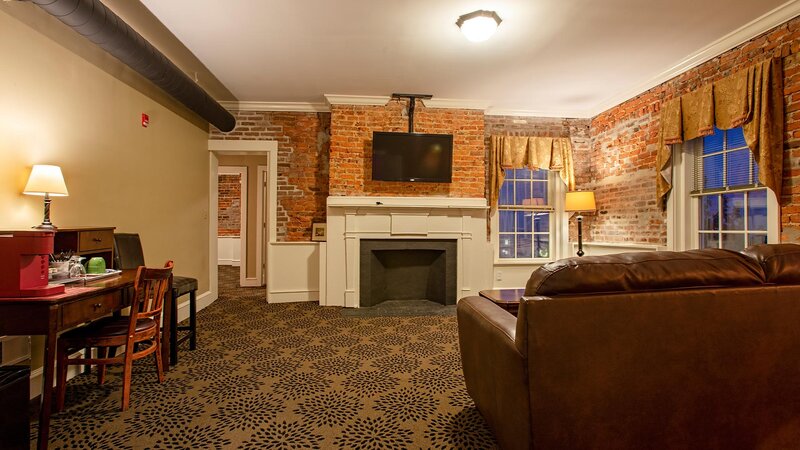 Living room with brick walls and mounted television