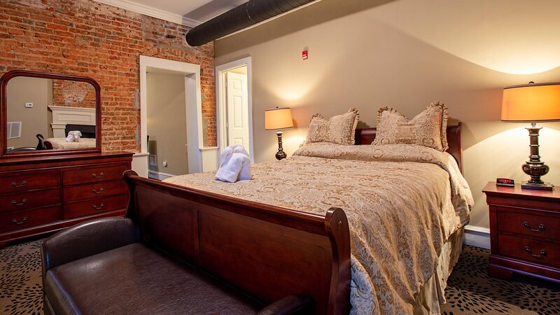 Bedroom with beige and brick walls