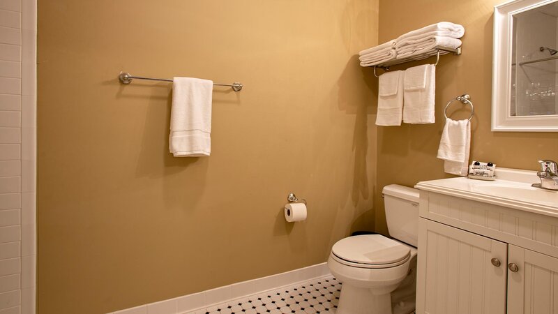 Bathroom with light brown walls and white fixtures
